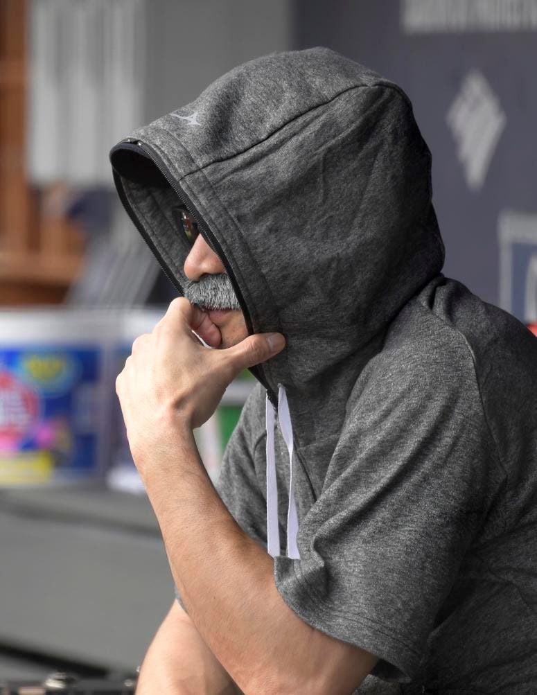 Ichiro Suzuki, special assistant to the chairman of the Seattle Mariners, wears a fake mustache and a hoodie as he sits in the dugout and watches the New York Yankees bat during the first inning of a baseball game at Yankee Stadium. Ichiro Suzuki, special assistant to the chairman of the Seattle Mariners, wears a fake mustache and a hoodie as he sits in the dugout and watches the New York Yankees bat during the first inning of a baseball game at Yankee Stadium.